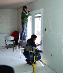 Students from Nicoma Park, First put finishing touches on sheetrock walls inside the new caretaker’s living space.