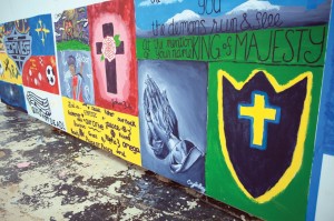 Cayla Ray, a student camper at Falls Creek, painted a portrait of hands in prayer at an art display at Falls Creek. She was among the many who made a decision at Falls Creek.