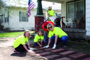 Burch family laying tiles