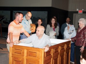 After many years of praying for her neighbors, Kristn Punjabi, center, holding towel, witnesses Edward Hurley’s baptism, after leading him to the Lord last summer.